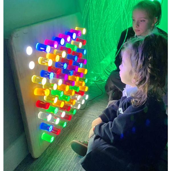 Wall hanging sensory light panel with coloured rods
